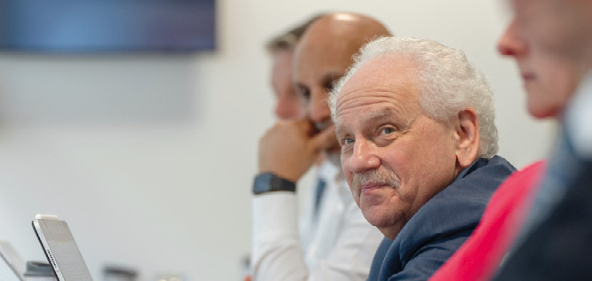 Board member portrait — male director with white hair